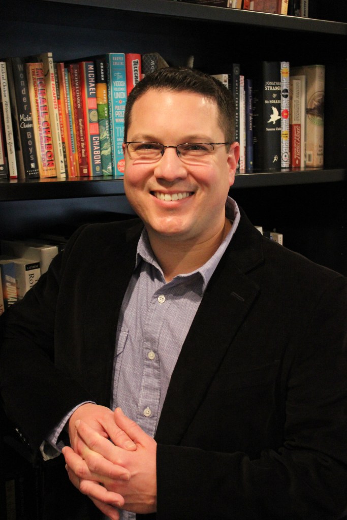 StandingBookshelfHandsFolded